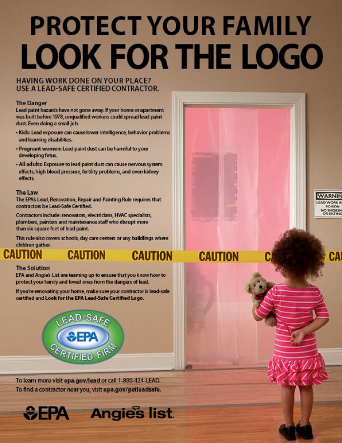 little girl standing in front of protective wall barrier